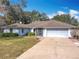 One-story house with a brown roof, attached garage, and a long driveway at 2810 Summerfield St, Deltona, FL 32738