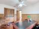 Home office with wood-paneled walls and built-in cabinets at 2810 Summerfield St, Deltona, FL 32738