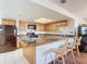 Kitchen with breakfast bar, black appliances, and wood cabinets at 2810 Summerfield St, Deltona, FL 32738