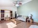 Living room with laminate floors, a sofa, and a large green accent wall at 2810 Summerfield St, Deltona, FL 32738