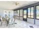 Enclosed porch with glass windows and patio furniture at 2810 Summerfield St, Deltona, FL 32738
