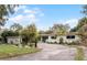 Mid-century modern home with landscaped yard and driveway at 3431 Wilder Ln, Orlando, FL 32804