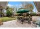Outdoor patio with seating area, umbrella, and lush landscaping at 3431 Wilder Ln, Orlando, FL 32804