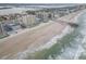 Aerial view of beachfront property with pier and ocean at 3724 S Atlantic Ave # 20, Daytona Beach, FL 32118