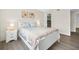 Bright bedroom with white sleigh bed, nightstand and walk-in closet at 3724 S Atlantic Ave # 20, Daytona Beach, FL 32118