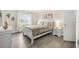 Bedroom with white sleigh bed, nightstand and ocean decor at 3724 S Atlantic Ave # 20, Daytona Beach, FL 32118
