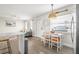 Bright dining area with white table and chairs near the kitchen at 3724 S Atlantic Ave # 20, Daytona Beach, FL 32118