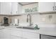 White quartz countertops and farmhouse sink in kitchen at 3724 S Atlantic Ave # 20, Daytona Beach, FL 32118