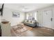 Cozy living room featuring a gray couch and wood-look floors at 3724 S Atlantic Ave # 20, Daytona Beach, FL 32118