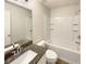 Modern bathroom with granite countertop and a white tile shower at 4047 Sw 51St Ct, Ocala, FL 34474