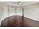 Large bedroom with dark hardwood floors and multiple doorways at 4047 Sw 51St Ct, Ocala, FL 34474
