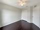 Well-lit bedroom with dark hardwood floors and double closets at 4047 Sw 51St Ct, Ocala, FL 34474
