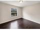 Bright bedroom with dark hardwood floors and a large window at 4047 Sw 51St Ct, Ocala, FL 34474