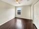 Spacious bedroom with dark hardwood floors and a window at 4047 Sw 51St Ct, Ocala, FL 34474