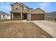 Two-story house with attached garage and landscaped lawn at 4047 Sw 51St Ct, Ocala, FL 34474