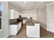 Modern kitchen with white cabinets, granite countertops, and stainless steel appliances at 4047 Sw 51St Ct, Ocala, FL 34474