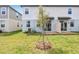 A backyard with a young tree and partial fence with a patio and grass at 4329 Switchgrass Ln, St Cloud, FL 34772