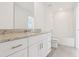 Modern bathroom with a white toilet, bathtub and tiled shower, and granite vanity at 4329 Switchgrass Ln, St Cloud, FL 34772