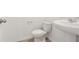 Cozy half bathroom showcasing a white toilet, pedestal sink, and simple hardware and finishes at 4329 Switchgrass Ln, St Cloud, FL 34772