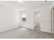 Carpeted bedroom with a view of the backyard and doorway to an en-suite bathroom at 4329 Switchgrass Ln, St Cloud, FL 34772
