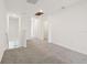 Bonus room with gray carpet and white walls leading to a linen closet and attic access at 4329 Switchgrass Ln, St Cloud, FL 34772