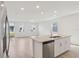 Modern kitchen island with granite countertops and stainless steel dishwasher overlooking living room at 4329 Switchgrass Ln, St Cloud, FL 34772