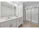 This lovely bathroom features double vanity sinks and a luxurious tiled shower with glass door at 4348 Ranch House Rd, St Cloud, FL 34772