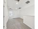 Hallway featuring neutral colored carpet, white walls and natural light at 4348 Ranch House Rd, St Cloud, FL 34772