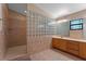 Bathroom boasts double vanity, glass block shower, and wood cabinets at 4938 Raylene Way, St Cloud, FL 34771