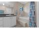 Bathroom featuring a built-in tub and vanity with storage at 4938 Raylene Way, St Cloud, FL 34771