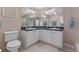 Double vanity bathroom with granite countertop and white cabinets at 4938 Raylene Way, St Cloud, FL 34771