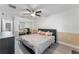Bedroom featuring a ceiling fan and closet with mirrored doors at 4938 Raylene Way, St Cloud, FL 34771