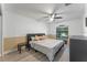 Bedroom with ceiling fan, beige and white walls, and wood-look floors at 4938 Raylene Way, St Cloud, FL 34771