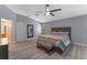 Spacious bedroom with wood-look floors and ceiling fan at 4938 Raylene Way, St Cloud, FL 34771