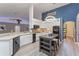 Modern kitchen with white cabinets, island, and stainless steel appliances at 4938 Raylene Way, St Cloud, FL 34771