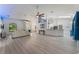 Open concept living room with vaulted ceilings and light colored flooring at 4938 Raylene Way, St Cloud, FL 34771