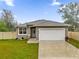 Newly built home with a white garage door and well-manicured lawn at 5211 Grace E St, Lakeland, FL 33810