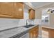 Kitchen with wood cabinets, granite countertops, and stainless steel sink at 526 Orange Dr # 37, Altamonte Springs, FL 32701