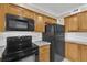 Kitchen with wood cabinets and black appliances at 526 Orange Dr # 37, Altamonte Springs, FL 32701