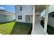 View of the backyard featuring a covered patio, green lawn, and well-kept exterior at 5374 Lake Virginia St, Winter Garden, FL 34787