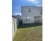 A spacious fenced backyard with lawn. The side yard has a view of neighboring home at 5374 Lake Virginia St, Winter Garden, FL 34787