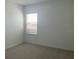 The bright bedroom is carpeted and has a large window with blinds and backyard view at 5374 Lake Virginia St, Winter Garden, FL 34787