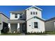 Charming two-story home with white facade, light blue accents, and a well-maintained front yard at 5374 Lake Virginia St, Winter Garden, FL 34787