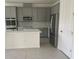 Modern kitchen with stainless steel appliances, gray cabinetry, and a stylish tile backsplash at 5374 Lake Virginia St, Winter Garden, FL 34787