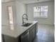 Kitchen island featuring a stainless steel dishwasher, sink, and modern faucet at 5374 Lake Virginia St, Winter Garden, FL 34787