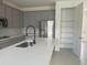 Contemporary kitchen with gray cabinets, stainless steel appliances, and spacious island at 5374 Lake Virginia St, Winter Garden, FL 34787