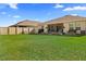 Spacious backyard with large grassy area, screened patio, and privacy fence at 5681 Arlington River Dr, Lakeland, FL 33811