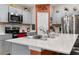 Kitchen features stainless steel appliances and white cabinets at 5681 Arlington River Dr, Lakeland, FL 33811