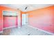 Small bedroom with peach walls and tiled floors at 5702 Meridian Way, Orlando, FL 32808