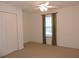 Bright bedroom with double door closet and ceiling fan at 870 Regatta Bay Dr # 4-103, Orange City, FL 32763